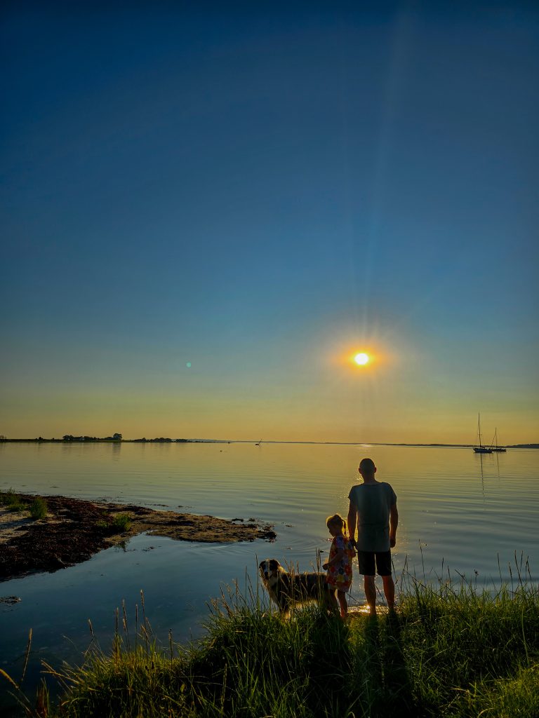 Family_sunset_ocean_denmark_summer_blue_sky_still_water