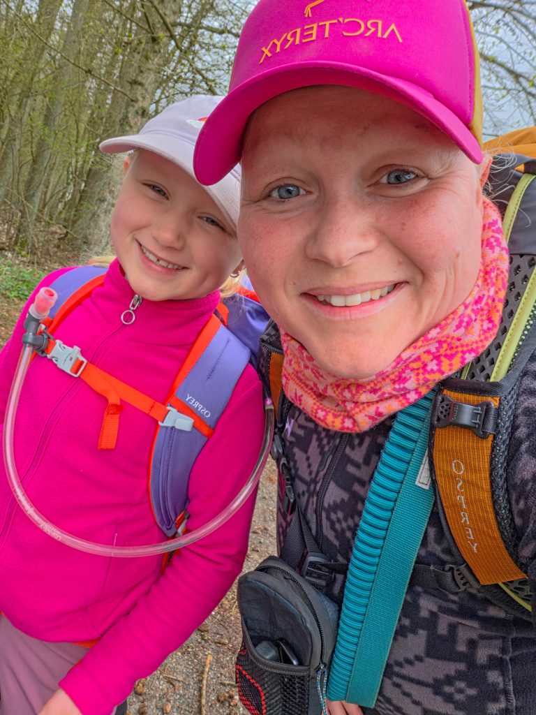Woman and child smiling together during a hiking trip in Denmark.