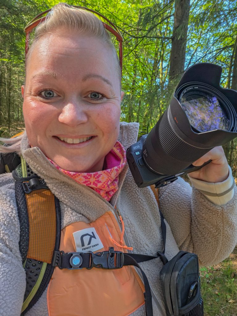 Woman photographer outside in the forest,