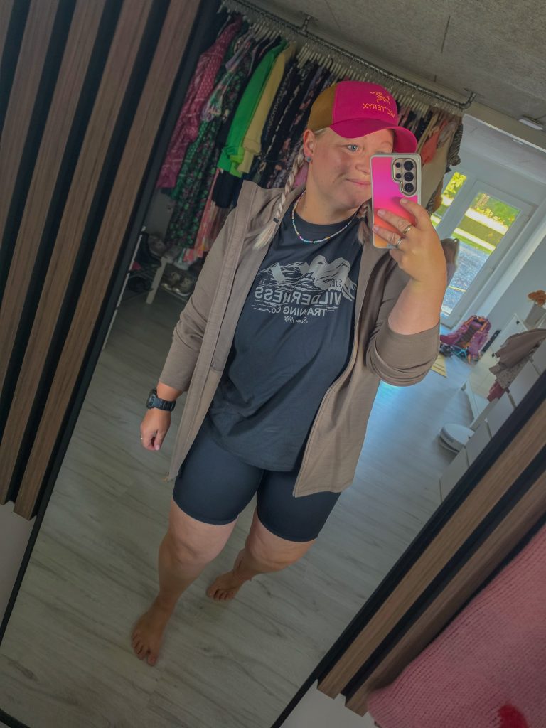 Woman trying on comfortable hiking clothes for a summer outdoor adventure.