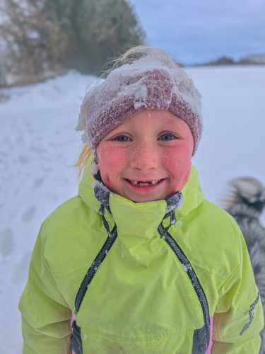 Kid portait with snow on the cheeks